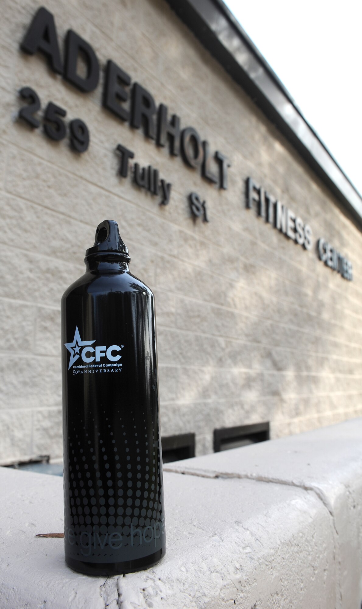A Combined Federal Campaign water bottle sits in front of the Aderholt Fitness Center on Hurlburt Field, Fla., Nov. 12, 2013.  Prizes such as water bottles and gift cards were given to the top four finishers of the 4th annual 5k fun run. (U.S. Air Force photo/Senior Airman Kentavist Brackin)
