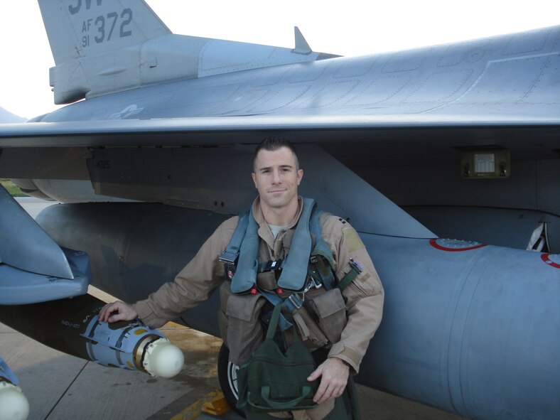 Maj. Adam Thornton, 56th Training Squadron instructor pilot, stands next to an F-16 Fighting Falcon at Aviano Air Base, Italy. Thornton deployed to Aviano in support of Operation Unified Protector where he received an Air Medal for acts above and beyond the call of duty. (Courtesy photo)