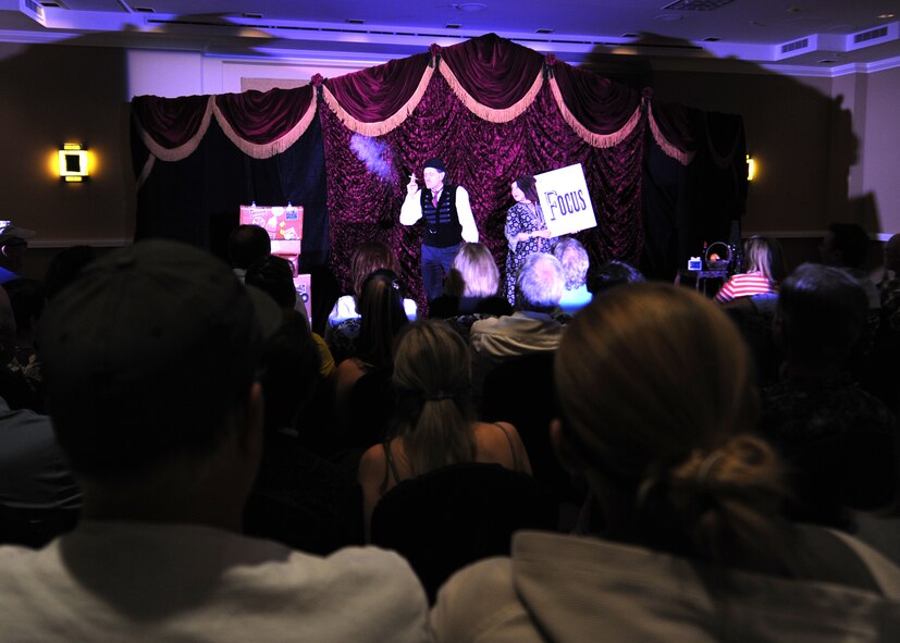 Roland Sarlot and Susan Eyed, master illusionists, perform before a live audience during a sold-out show. “Carnival” is a whimsical mix of vaudeville comedy and clever illusions. (U.S. Air Force photo/Staff Sgt. Nestor Cruz)