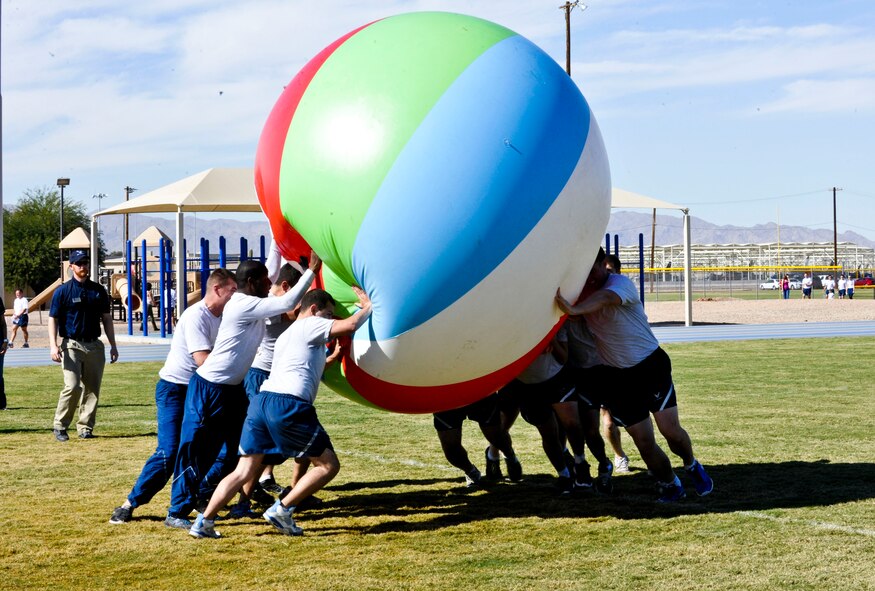 The 56th Logistics Readiness Squadron team, left, pushes the ball toward the goal line as the 56th Security Forces Squadron team pushes back Nov. 8 during a combat football game. SFS fought back and defeated LRS. (U.S. Air Force photo/Senior Airman David Owsianka)