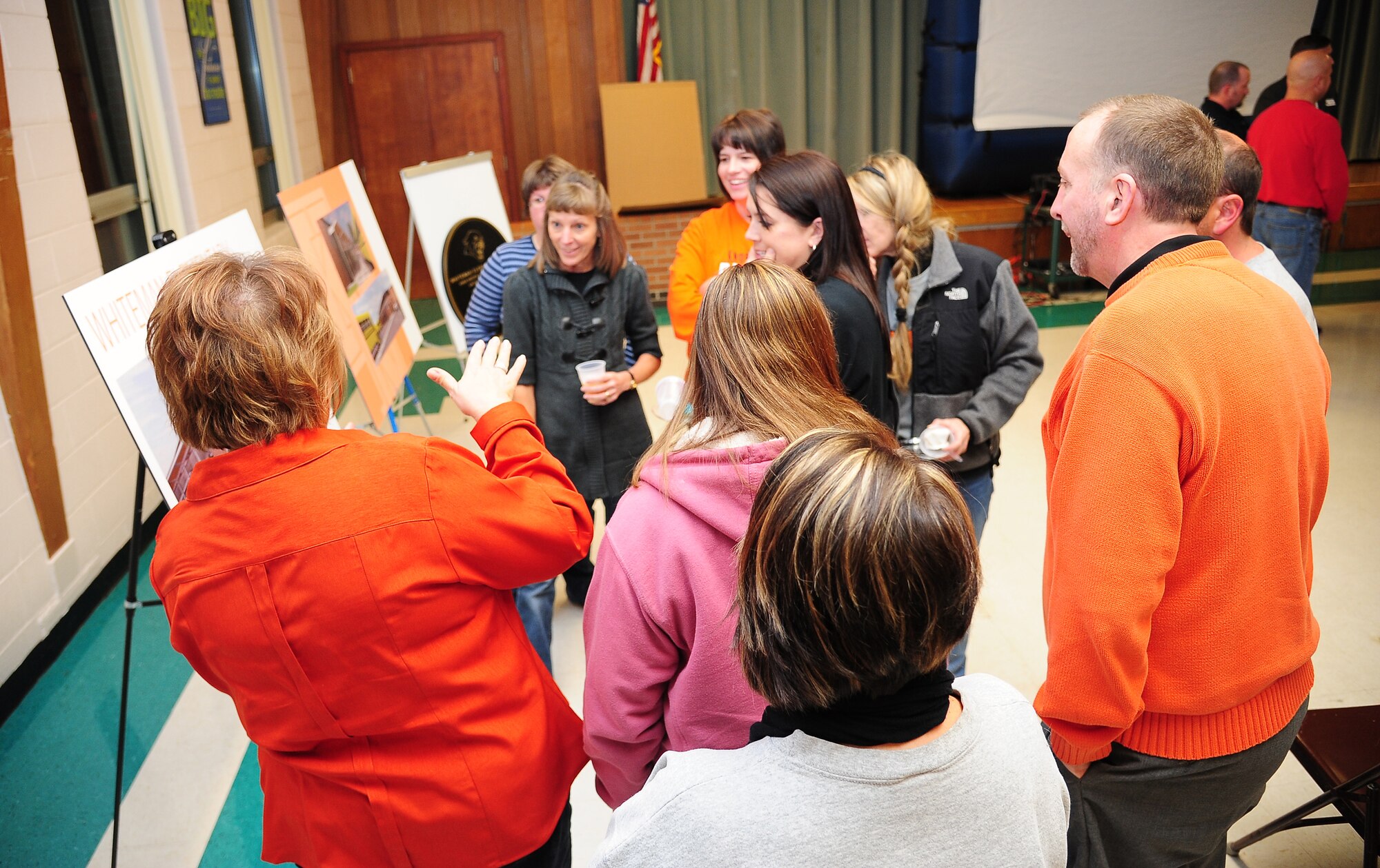 Attendees discuss planned improvements of Knob Noster R-VIII School District schools during the Whiteman Elementary School rededication ceremony at Whiteman Air Force Base, Mo., Nov. 14, 2013. Whiteman, whose school lease has been extended through 2041, is one of many Knob Noster schools that will benefit from construction projects planned to start in early 2014. (U.S. Air Force photo by Staff Sgt. Brigitte N. Brantley/Released)