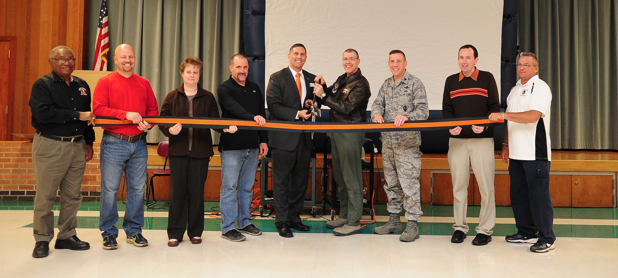 Dr. Jaret Tomlinson, center, Knob Noster R-VIII School District superintendent;, U.S. Air Force Brig. Gen. Thomas A. Bussiere, 509th Bomb Wing commander,; and Lt. Col. Richard Goodman, 509th Mission Support Group deputy commander, along with other school board members, celebrate the rededication of Whiteman Elementary School, Nov. 13, 2013, at Whiteman Air Force Base, Mo. The school’s lease has been renewed through 2041. (U.S. Air Force photo by Staff Sgt. Brigitte N. Brantley/Released)