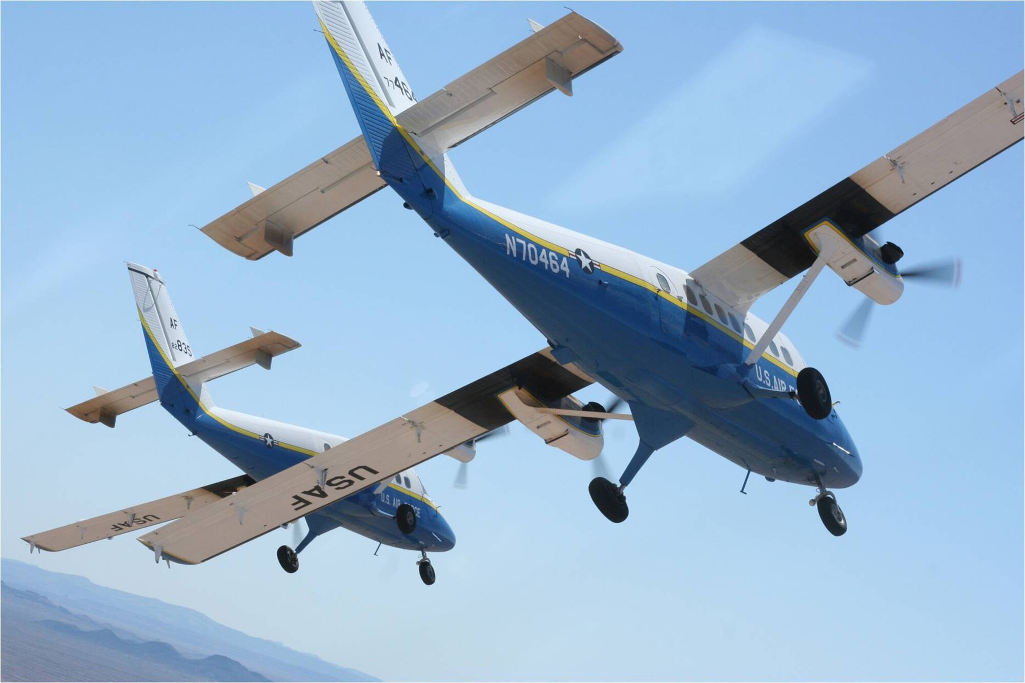 A U.S. Air Force Academy Twin Otter UV-18B flies over the Academy. This airlift support plane is used for cadet parachuting and the Air Force Wings of Blue parachute team. The Academy hosted a town hall meeting on Nov. 12 with Colorado Springs residents to discuss recent FAA-mandated changes to it's training flying pattern. 