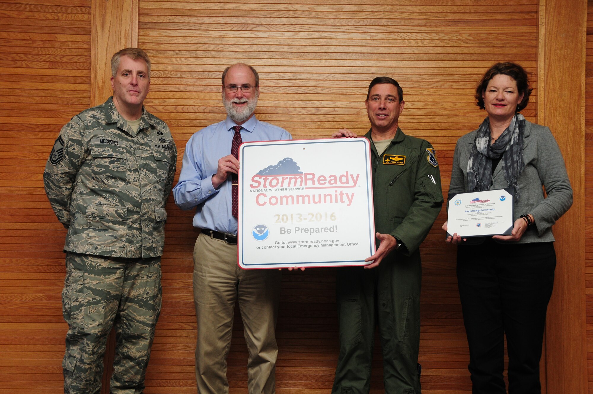 Carol Christenson and Michael Stewart from the National Weather Service present Col. Frank H. Stokes, 148th Fighter Wing Commander and Senior Master Sgt. Kelvin R. McCuskey, Installation Emergency Manager with a StormReady sign and certificate at the 148th Fighter Wing, Duluth, Minn., Nov. 13, 2013.  The sign and certificate recognized the Wing for being a StormReady community for another three years.  (U.S. Air National Guard photo by Master Sgt. Ralph J. Kapustka/Released)