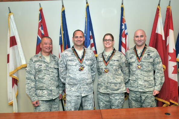 SCOTIA, N.Y. -- (From left) Maj. Benson Louie, Col. John Russo, Master Sgt. Nicole DellaRocco and Maj. Ryan Walsh all participated in the Marine Corps Marathon on Oct. 27, 2013, in Arlington, Va. 1st Lt. Tierra Oliver (not pictured) was another 109th Airlift Wing member who participated in the marathon. Although not pictured, all participants received medals for completing the marathon. (Air National Guard photo by Master Sgt. William Gizara/Released)
