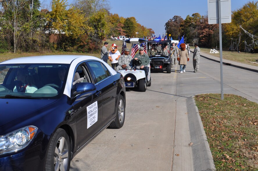Col. Christopher Azzano, 72nd Air Base Wing and Tinker installation commander, accompanied by his wife, leads Col. André Kennedy, 552nd Maintenance Group commander, and Chief Master Sgt. John  Mackey, 552nd MXG; and other members of Team Tinker  at the start of the Veterans Day Parade in Midwest City Nov. 11. (Air Force photos by Jerry Bryza)