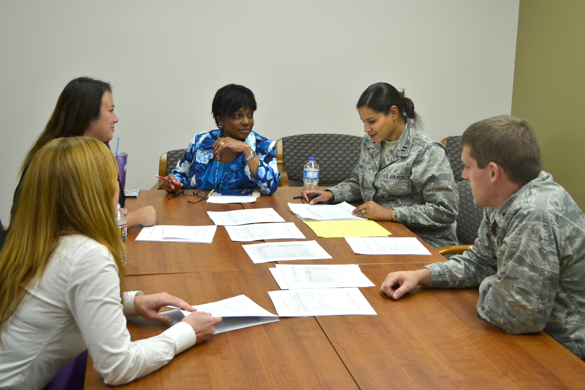 Mental Health Flight personnel meet. From left to right: Licensed Clinical Social Worker Hollis Ferrell, Psychologist Jerri Turner, Licensed Clinical Social Worker Valerie Tucker, Psychologist Capt. Mayrin Munguia and Psychologist Capt. Spencer Clayton.(Air Force photo by Brandice J. O’Brien)