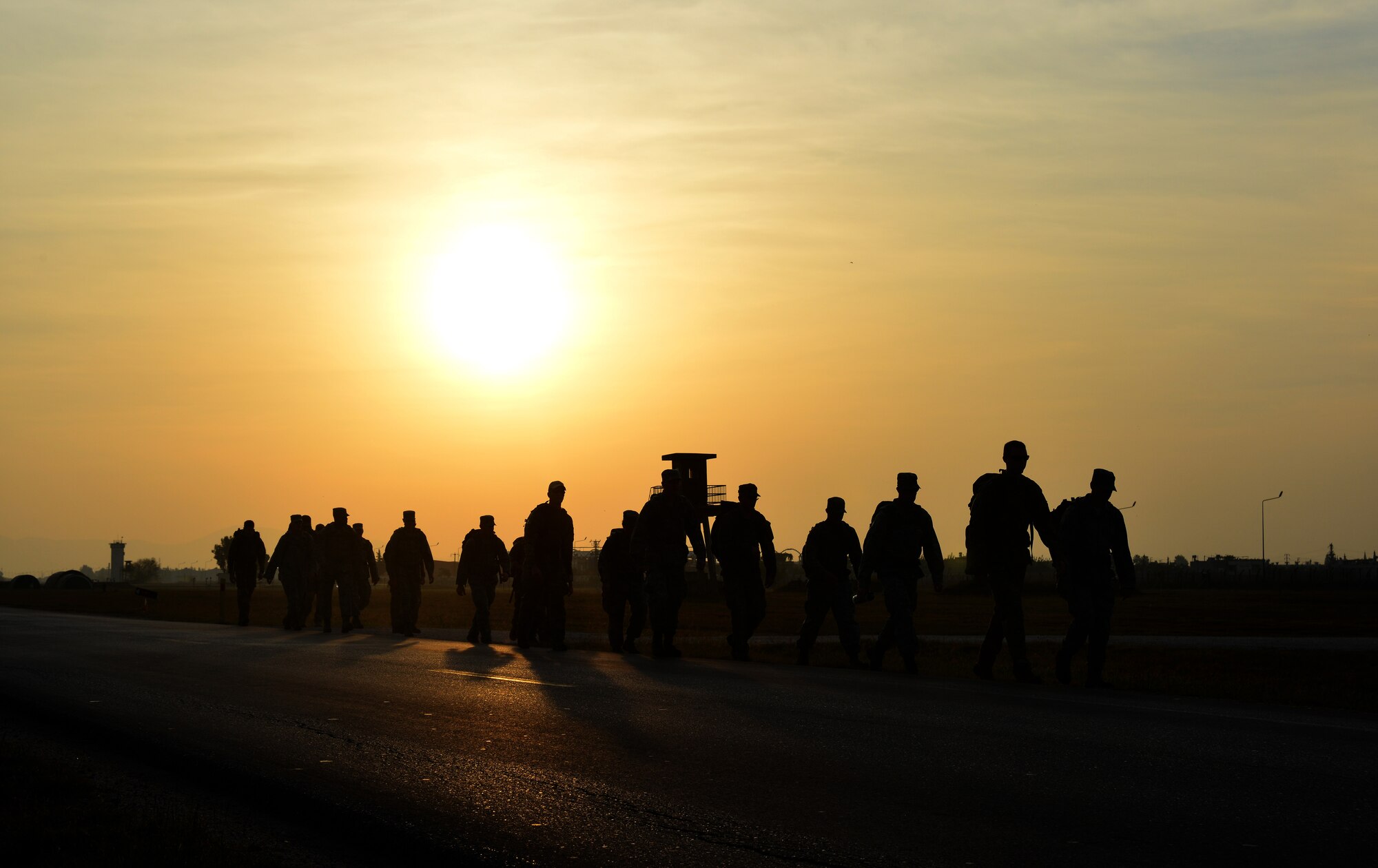 Members of the 39th Civil Engineer Squadron Explosive Ordinance Disposal Flight, along with 39th Air Base Wing leadership, march down a road with backpacks containing sand bags Nov. 12, 2013, at Incirlik Air Base, Turkey. The march was one of many activities for EOD Safety Day. (U.S. Air Force photo by Staff Sgt. Eric Summers Jr./Released)