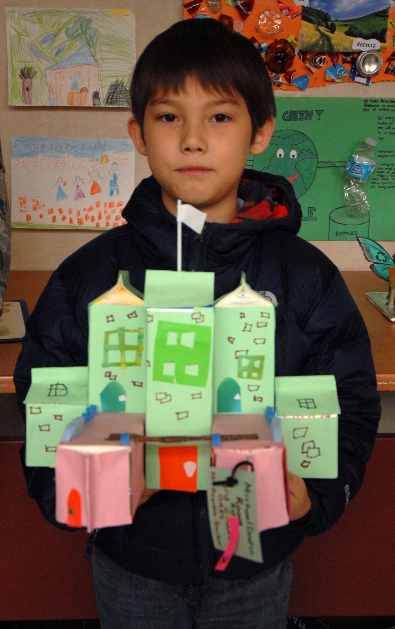 Michael Destin shows off his recycled art project at Osan Air Base, Republic of Korea, Nov. 14, 2013. Destin won second place in the art contest held to raise awareness of recycling benefits and processes. (U.S. Air Force photo/1st Lt. Kay M. Nissen)