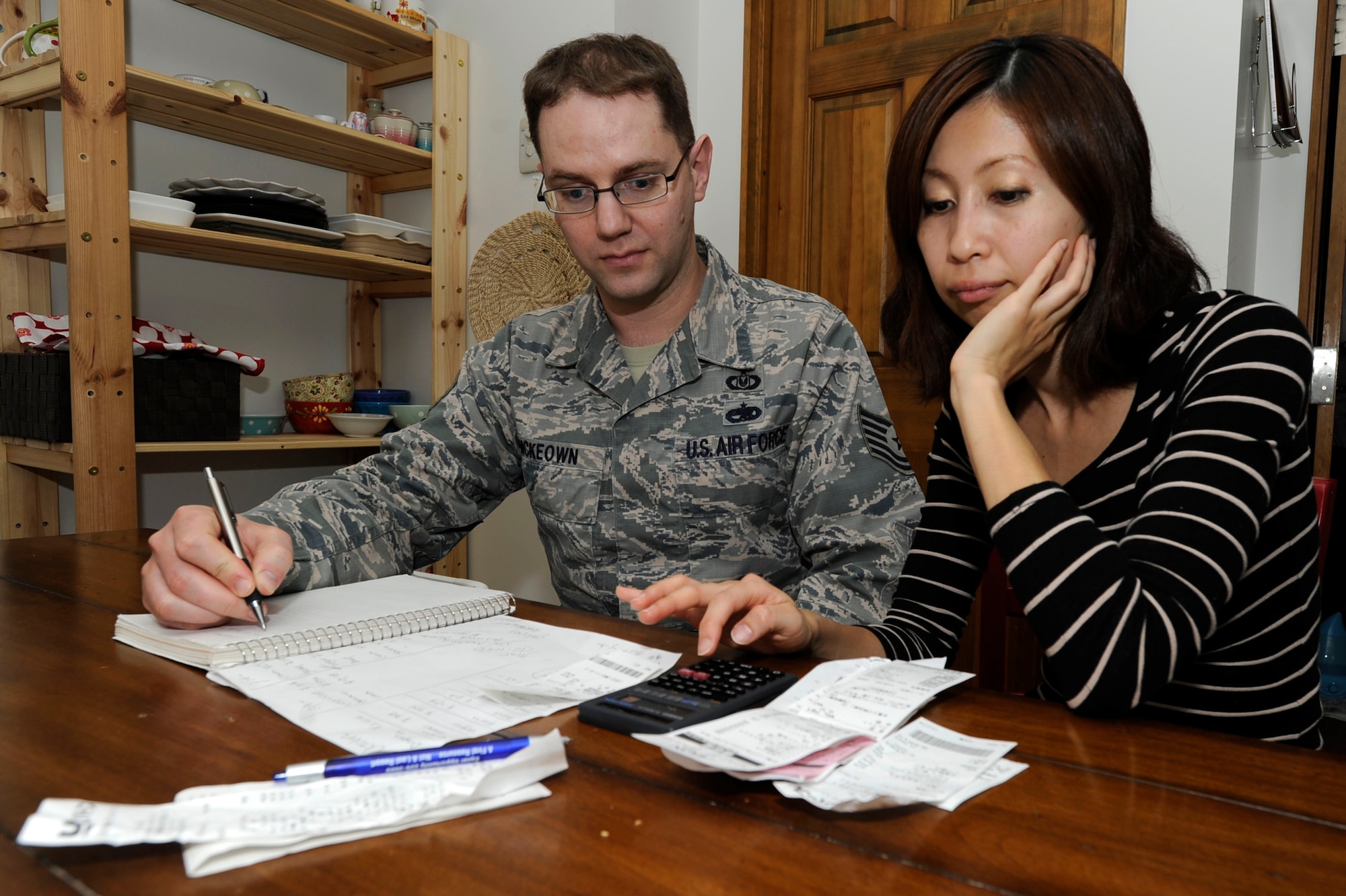 MISAWA AIR BASE, Japan -- Tech. Sgt. Logan McKeown, 35th Fighter Wing NCO in charge of ground safety, balances the budget with his wife at Misawa Air Base, Japan, Nov. 14, 2013. The Mckeowns spent nearly $10,000 settling their family into the local area after relocating from Mountain Home Air Force Base, Idaho, three months ago. Knowing that the move would test the limits of his family’s savings, they prepared for the move the best they could. (U.S. Air Force photo by Staff Sgt. Tong Duong)