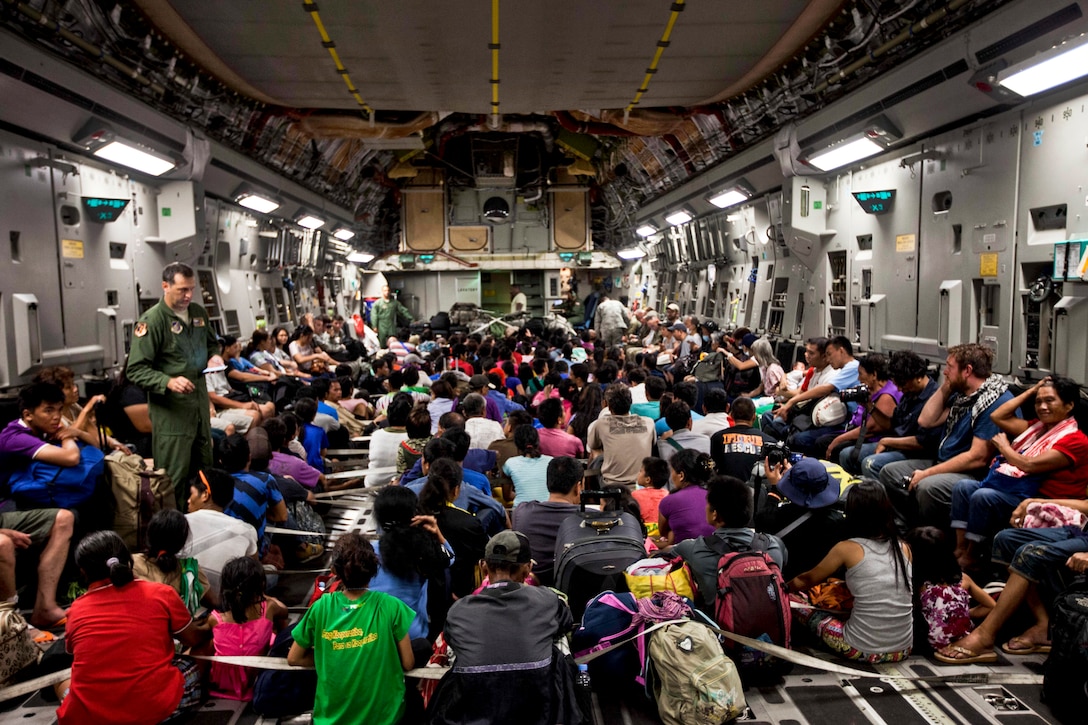 Displaced people of the Philippines and international personnel prepare for takeoff inside a C-17 Globemaster III during Operation Damayan from Tacloban Air Base to Manila, Nov. 15, 2013. The aircraft is assigned to the 535th Air Lift Squadron from Hickam Field, Honolulu. The 3rd Marine Expeditionary Unit is supporting the Philippine armed forces in providing humanitarian aid and disaster relief to areas affected by Typhoon Haiyan. U.S. Marine Corps photo by Sgt. Jonathan Wright