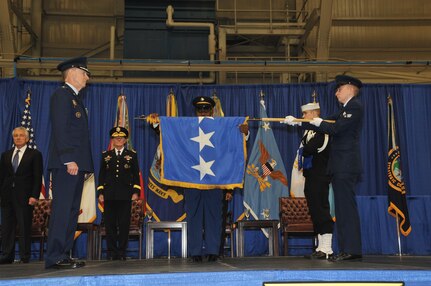 General C. Robert Kehler, outgoing commander, U.S. Strategic Command watches as his general officer flag is furled marking his retirement during the U.S. Strategic Command change of command ceremony at Offutt Air Force Base, Omaha, Nebraska Nov. 15, 2013. (Photo by Steve Cunningham / Released)
