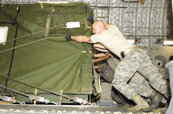 Airmen from the 733rd Air Mobility Squadron load supplies onto a C- 17 Globemaster III from Joint Base Pearl Harbor-Hickam, Hawaii, on Kadena Air Base, Japan, Nov. 15, 2013. More than 50 Marines along with members of the Air Force, Army and Navy will be heading to the Philippines to assist the locals recover from Super Typhoon Haiyan. (U.S. Air Force photo/Senior Airman Marcus Morris) 