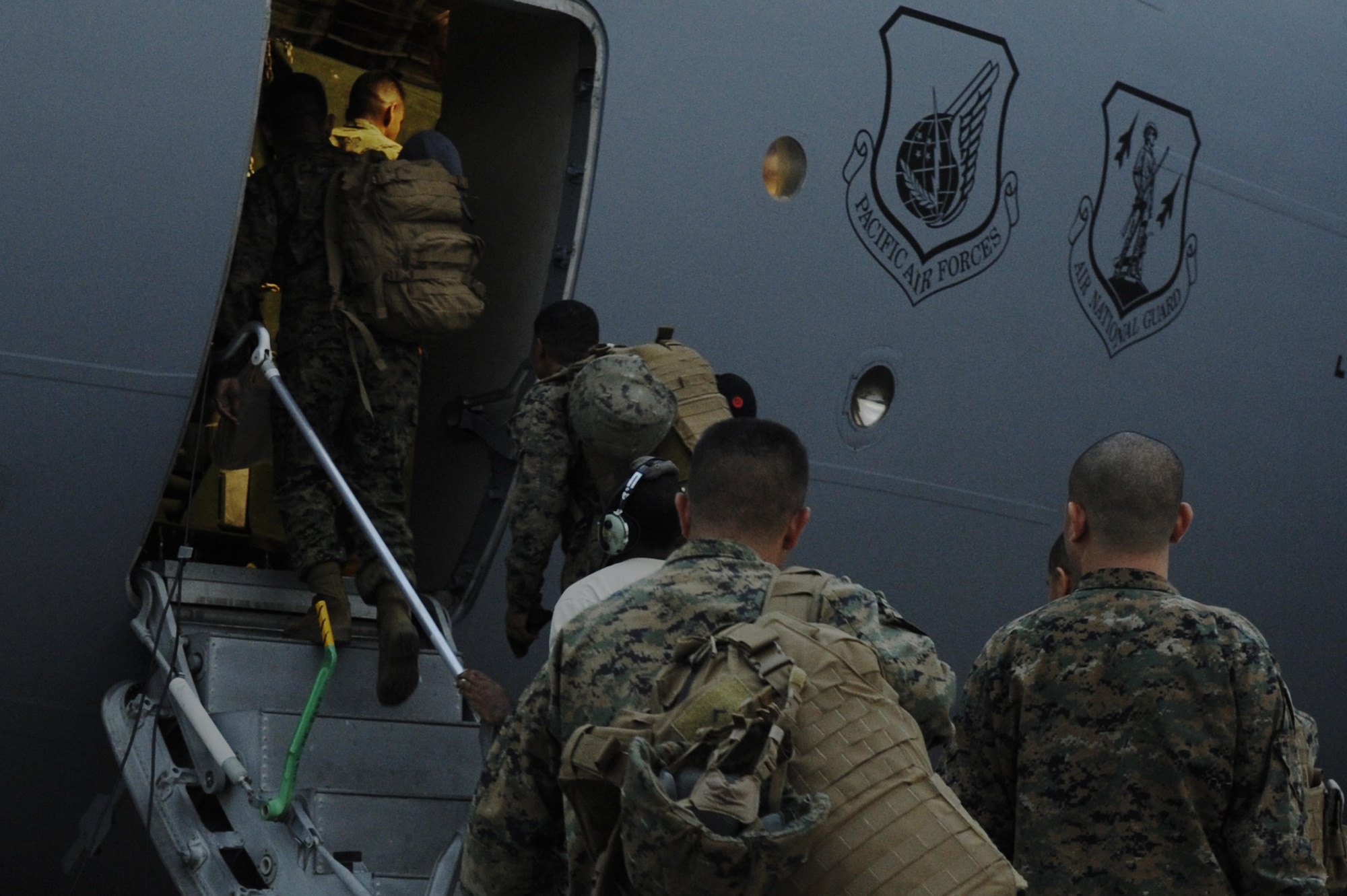 More than 50 Marines from the III Expeditionary Force at Marine Corps Air Station Futenma, Okinawa, Japan, load onto a C- 17 Globemaster III from Joint Base Pearl Harbor-Hickam, Hawaii, on Kadena Air Base, Japan, Nov. 15, 2013. The Marines are part of Joint Task Force 505, and will be assisted by U.S. Air Force, Army and Navy to bring relief to the people of the Philippines. (U.S. Air Force photo/Senior Airman Marcus Morris)