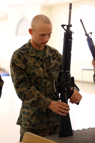 After assembling an M16-A4 service rifle, Recruit Dakota A. Bahr, Platoon 3205, Company I, 3rd Recruit Training Battalion, performs a functions check to ensure his rifle properly fires during the practical examination aboard the depot, Nov. 5. 