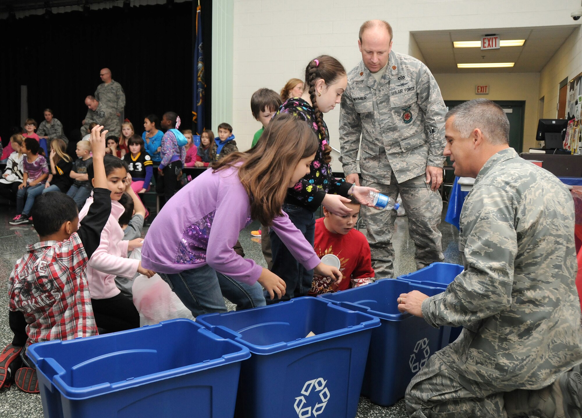 Lt. Col. Kris Kollar (right) and Maj. James Wymer, 193rd Special Operations Logistics Readiness Squadron, helps students at Fink Elementary School, Middletown, Pa., sort recyclables during an educational program held in conjunction with America Recycles Day. (U.S. Air National Guard photo by Staff Sgt. Susan Penning/Released)
