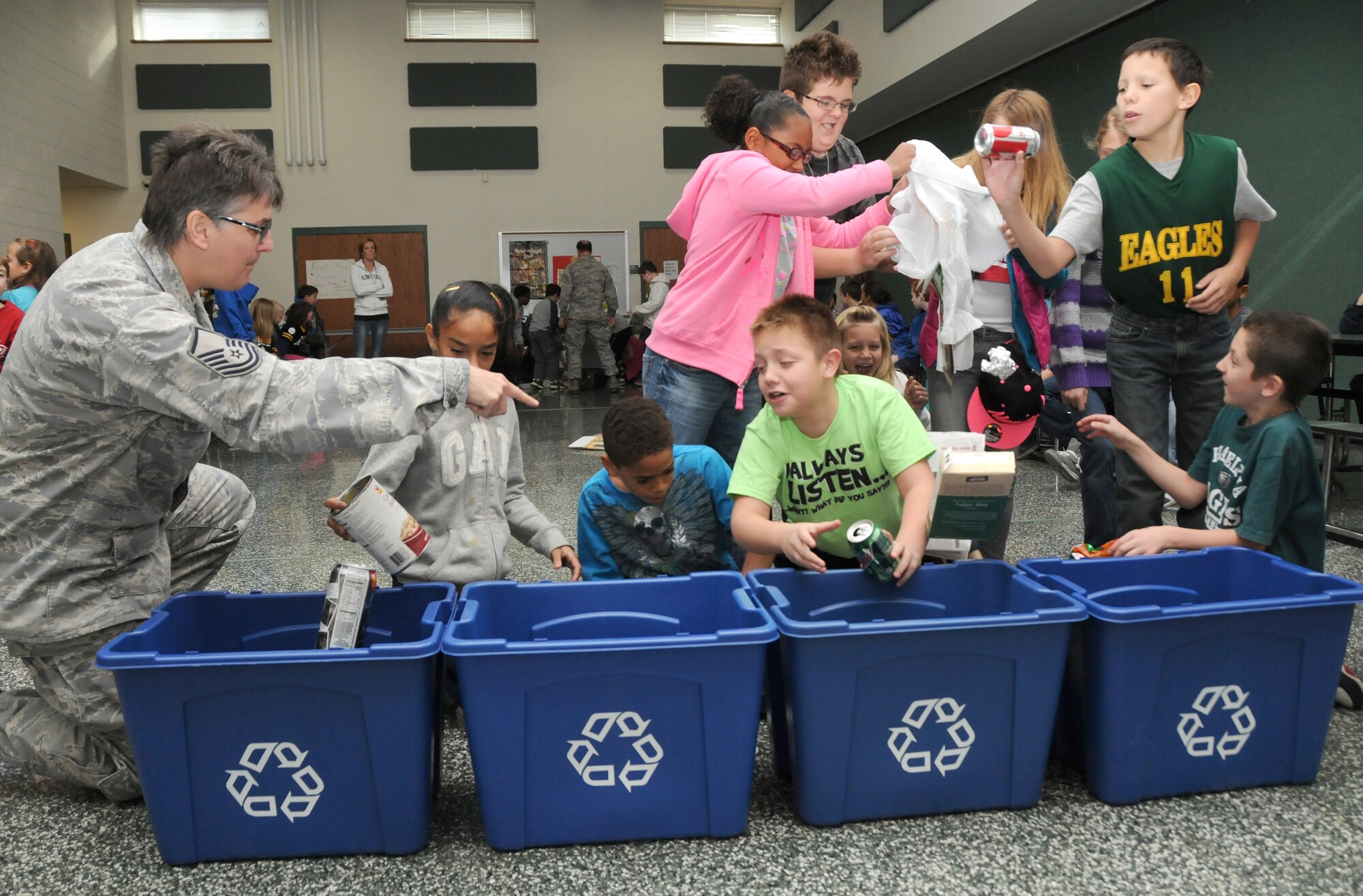 Master Sgt. Dorothy Wozniak (left), 193rd Special Operations Logistics Readiness Squadron, helps students at Fink Elementary School, Middletown, Pa., sort recyclables during a race held in conjunction with America Recycles Day. (U.S. Air National photo by Staff Sgt. Susan Penning/Released)