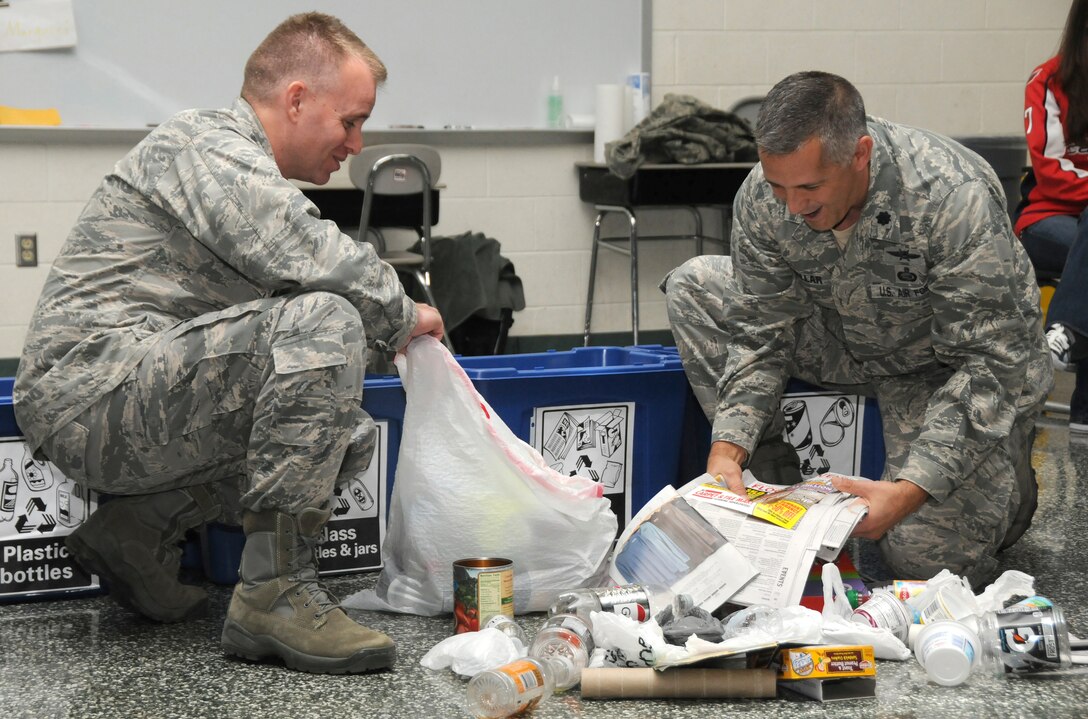 Second Lt. Thomas Bagnell (left) and Lt. Col. Kris Kollar, 193rd Special Operations Logistics Readiness Squadron, demonstrate how to sort recyclables Nov. 15 during an America Recycles Day educational program at Fink Elementary School, Middletown, Pa. (U.S. Air National Guard photo by Staff Sgt. Susan Penning/Released)