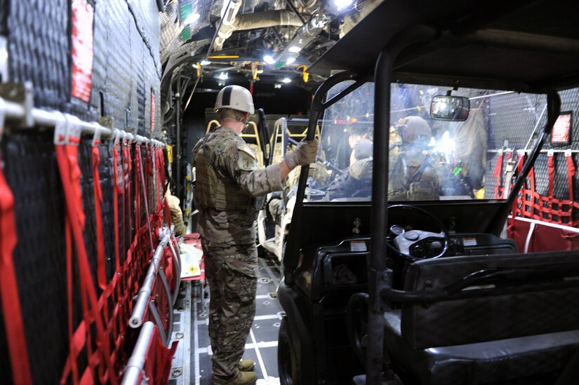 U.S. Special Forces operators from the 7th Special Forces Group (Airborne) prepare to exit a C-130 Hercules aircraft as part of RAPIDS infiltration/exfiltration training at Soto Cano Air Base, Nov. 15, 2013.  RAPIDS is a Special Forces tactic for quickly inserting and removing personnel into and out of an area, and is used for personnel recovery of an isolated individual.  (Photo by Martin Chahin)