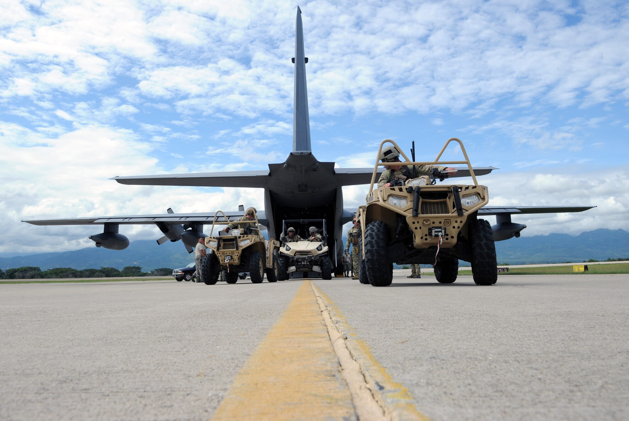 U.S. Special Forces operators from the 7th Special Forces Group (Airborne) exit a C-130 Hercules aircraft as part of RAPIDS infiltration/exfiltration training at Soto Cano Air Base, Nov. 15, 2013.  RAPIDS is a Special Forces tactic for quickly inserting and removing personnel into and out of an area, and is used for personnel recovery of an isolated individual.  (Photo by Martin Chahin)
