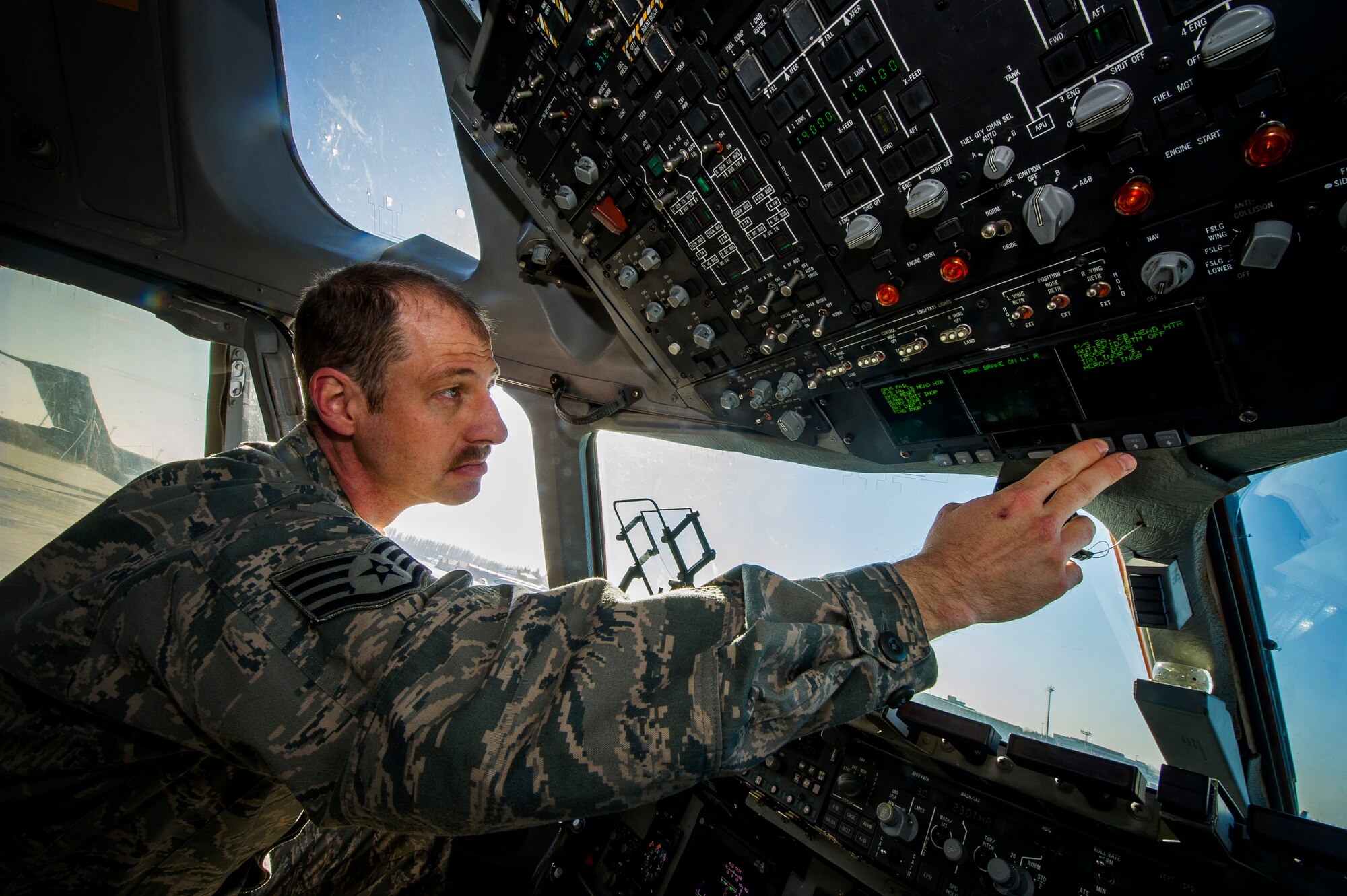 Staff Sgt. Caleb Cunningham, 728th Aircraft Maintenance Squadron aircraft electrician, performs a spot check during pre-flight checks on a C-17 Globemaster III, Nov. 14, 2013, at Transit Center at Manas, Kyrgyzstan. Cunningham is deployed from Memphis Air National Guard Base, and is a native of Memphis, Tenn. (U.S. Air Force photo/ Senior Airman George Goslin)