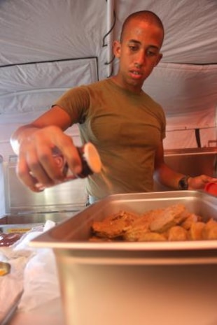 Lance Cpl. Clemente Jimenez, from Bronx, NY., seasons steak patties inside an expeditionary field kitchen on Tinian’s North Field Nov. 9 during exercise Forager Fury II. The patties were part of the first meal prepared in the EFK. Jimenez is a food service specialist with Marine Wing Support Squadron 171, Marine Aircraft Group 12, 1st Marine Aircraft Wing, III Marine Expeditionary Force.


