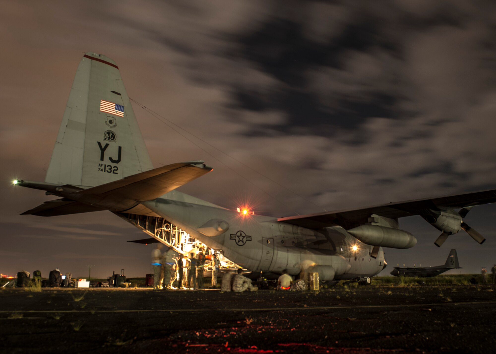 Airmen from Yokota Air Base, Japan, prepare to offload equipment from a C-130 Hercules at Clark Air Base, Republic of the Philippines, Nov. 16, 2013. The C-130 is considered a tactical airlift workhorse; capable of preforming air-land and airdrop missions out of remote locations. The Airmen have arrived in the Philippines to support Operation Damayan, a multi-national relief effort to assist the Philippine government’s response to the aftermath of Super Typhoon Haiyan/Yolanda.  (U.S. Air Force photo by Captain Raymond Geoffroy/Released)