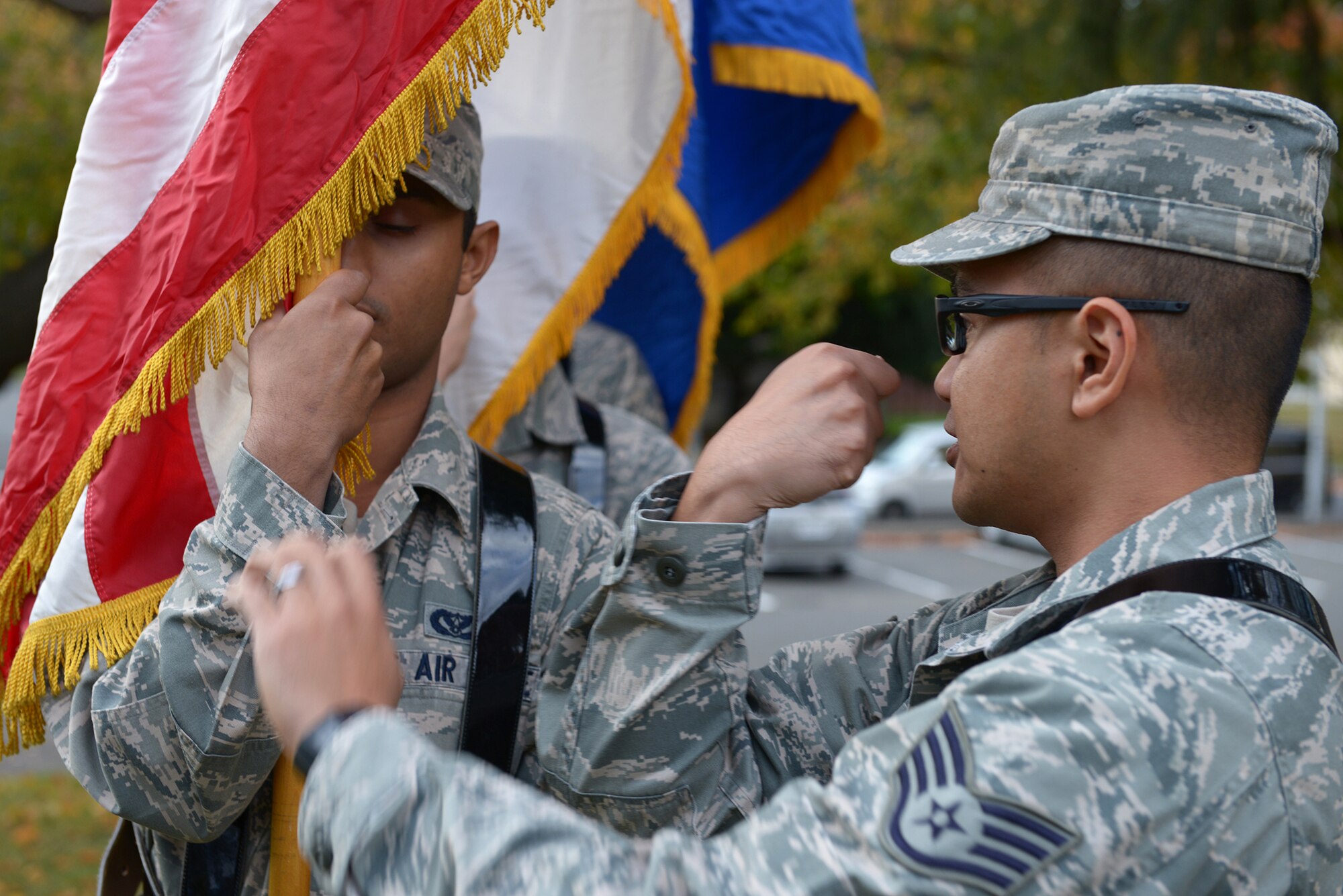 Staff Sgt. Carlo Almazan, member of the Yokota Air Base Honor Guard, demonstrates the correct grip for flag carriers at Yokota Air Base, Japan, Nov. 13, 2013. When not serving as a ceremonial guardsman, Almazan works as an ear, nose and throat technician with the 374th Surgical Operations Squadron. (U.S. Air Force photo by Airman 1st Class David Danford/Released)