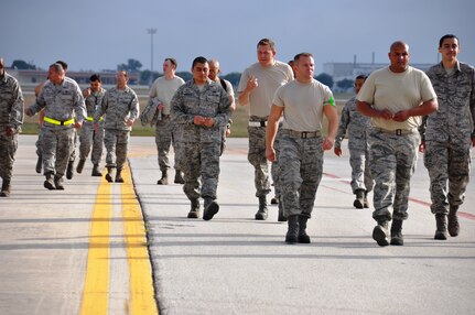 The 433rd Airlift Wing held a wing-wide FOD walk during the a mainteance stand down,  Nov. 17. The Airmen competed in a search for foreign object damage on the flight line to include two commander's coins. (U.S. Air Force photo/Technical Sgt. Carlos J. Trevino)