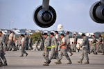 The 433rd Airlift Wing held a wing wide FOD walk on the Nov. 17 during Maintenance Group's down-day, Rodeo. Airmen competed in teams to search for foreign object damage on the flight line. Included in the FOD were two commander's coins. (U.S. Air Force photo/Technical Sgt. Carlos J. Trevino)