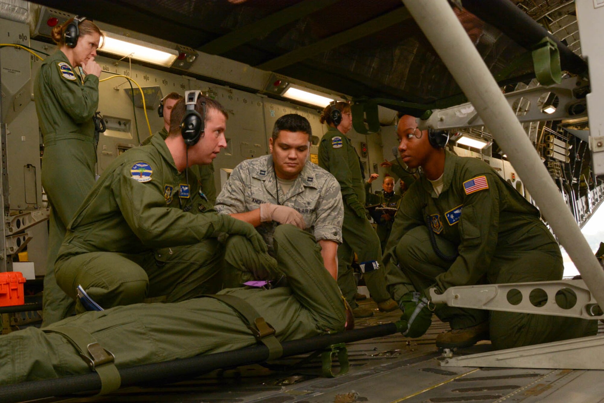 Members of the 315th Aeromedical Evacuation Squadron prepare a patient for transport on board a C-17 Globemaster III aircraft Nov. 17, 2013 during a routine training flight at Joint Base Charleston, S.C. (U.S. Air Force Photo by Tech. Sgt. Shane Ellis/released)
