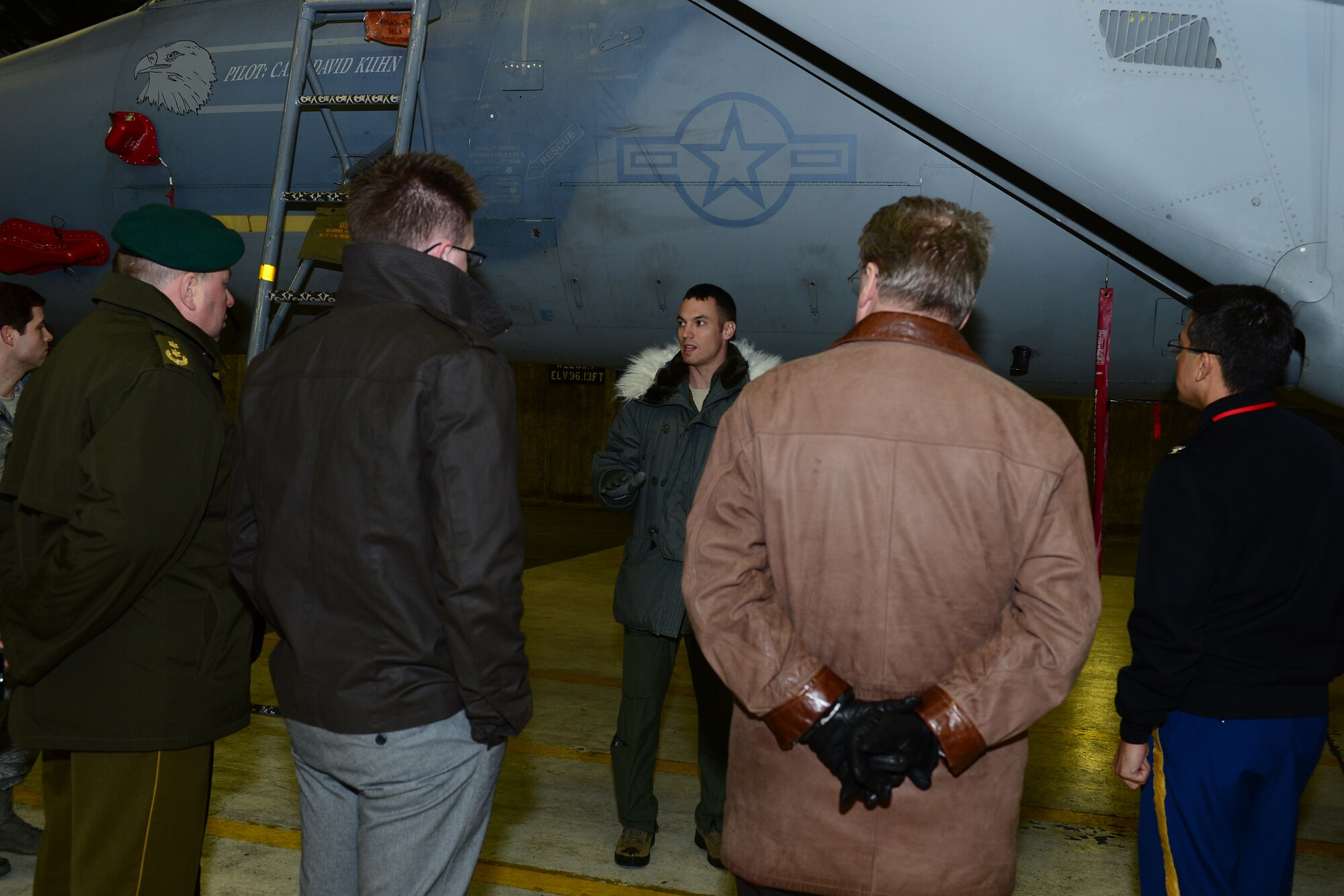 Maj. Jason Bianchi, 48th Air Expeditionary Group liaison officer, speaks to members of the Baltic Defence College on the capabilities of the F-15C Eagle during a tour at Keflavik International Airport, Iceland, Nov. 14, 2013. The 48th Air Expeditionary Group conducts tours to highlight and further explain why the U.S.  Air Force conducts air policing and surveillance missions while deployed to Iceland. Visiting groups also received aircraft static displays of a KC-135 Stratotanker and a C-130J. (U.S. Air Force photo by Airman 1st Class Dana J. Butler/Released)