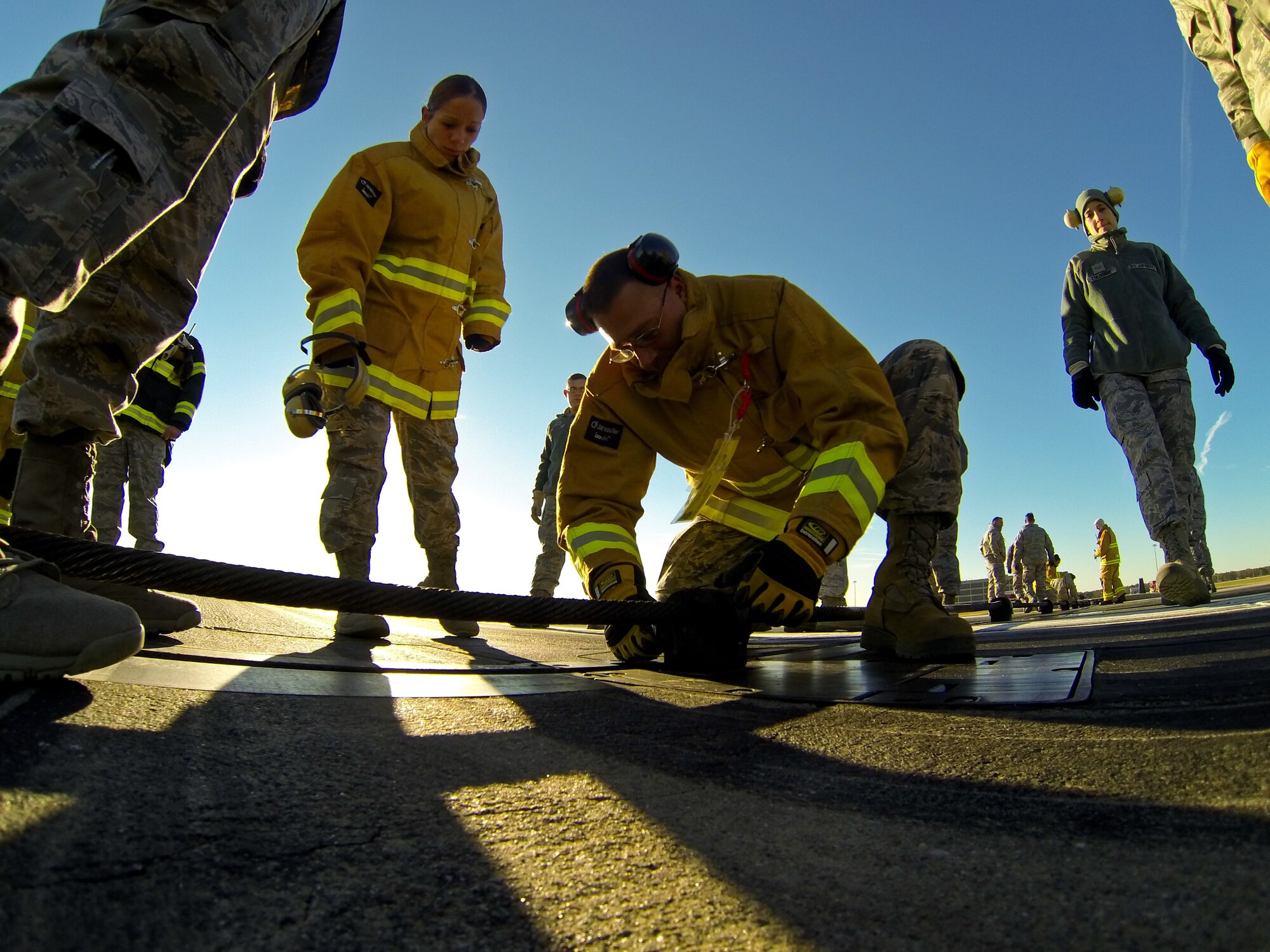 A picture of U.S. Air Force airmen from the 177th Fighter Wing resetting a cable.