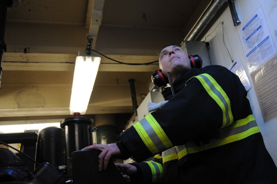 An airman from the 177th Civil Engineering Squadron Fire Department awaits a signal during a test of the runway aircraft arrest system Nov. 14, 2013, at the 177th Fighter Wing at Atlantic City Air National Guard Base, N.J. The arrest system is used to stop aircraft in the event of a brake failure and must be tested yearly. (U.S. Air National Guard photo by Airman First Class Shane Karp/Released)