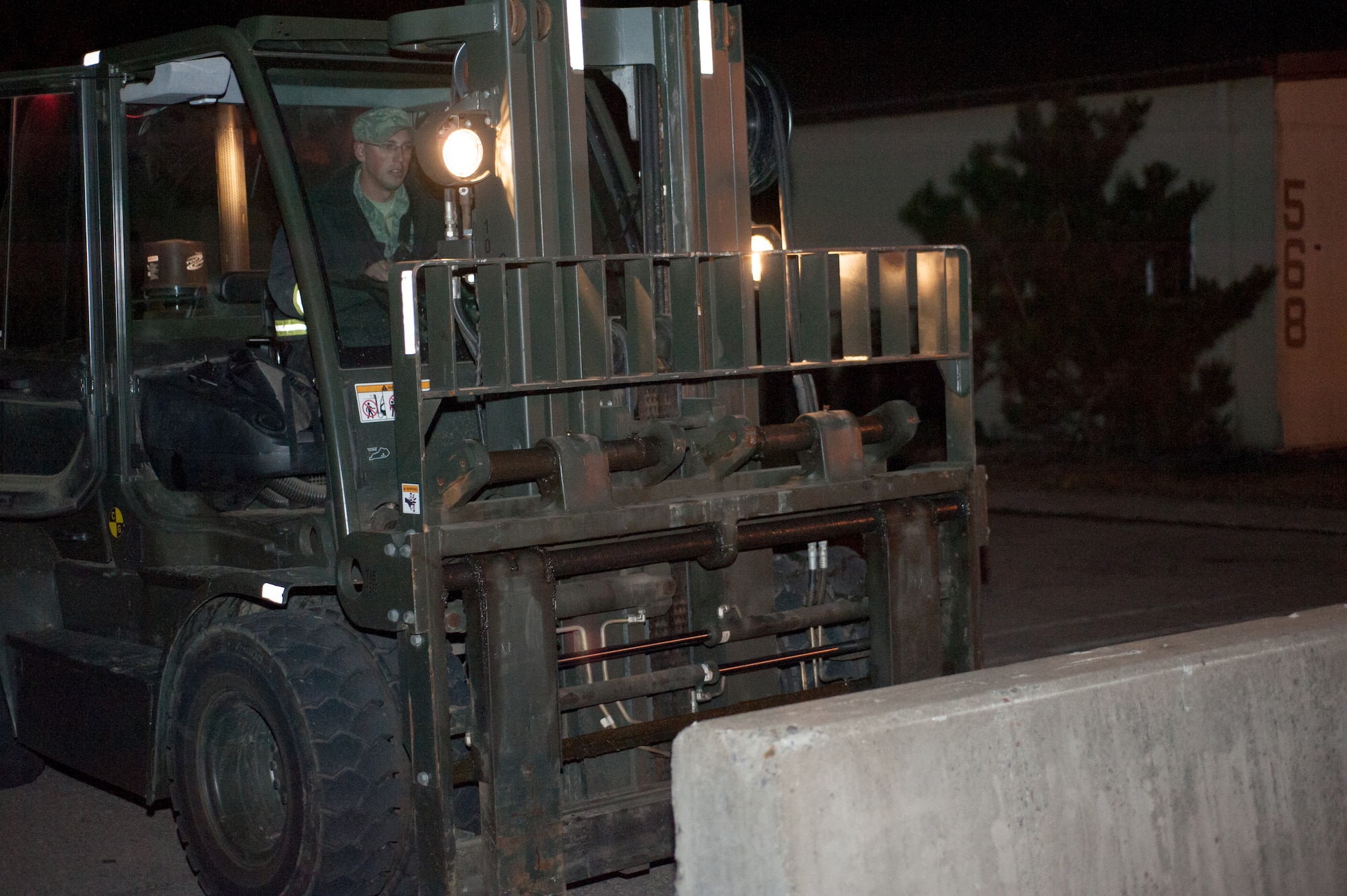 Senior Airman Justin Girbach, 8th Civil Engineer Squadron, prepares defense barriers for a scenario simulating hostile field conditions during exercise Beverly Bulldog 14-1 at Kunsan Air Base, Republic of Korea, Nov. 17, 2013. The 8th Fighter Wing is testing its wartime mission alongside other 7th Air Force units and supporting organizations with an emphasis on the operational and tactical levels of war during the peninsula-wide exercise. (U.S. Air Force photo by Senior Airman Armando A. Schwier-Morales/Released)
