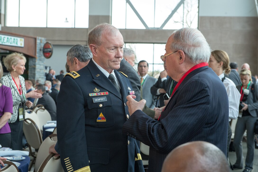 Army Gen. Martin E. Dempsey, chairman of the Joint Chiefs of Staff, speaks with U.S. Sen. Carl Levin of Michigan, right, during the Reagan National Defense Forum at the Reagan Presidential Library in Simi Valley, Calif., Nov. 16, 2013.