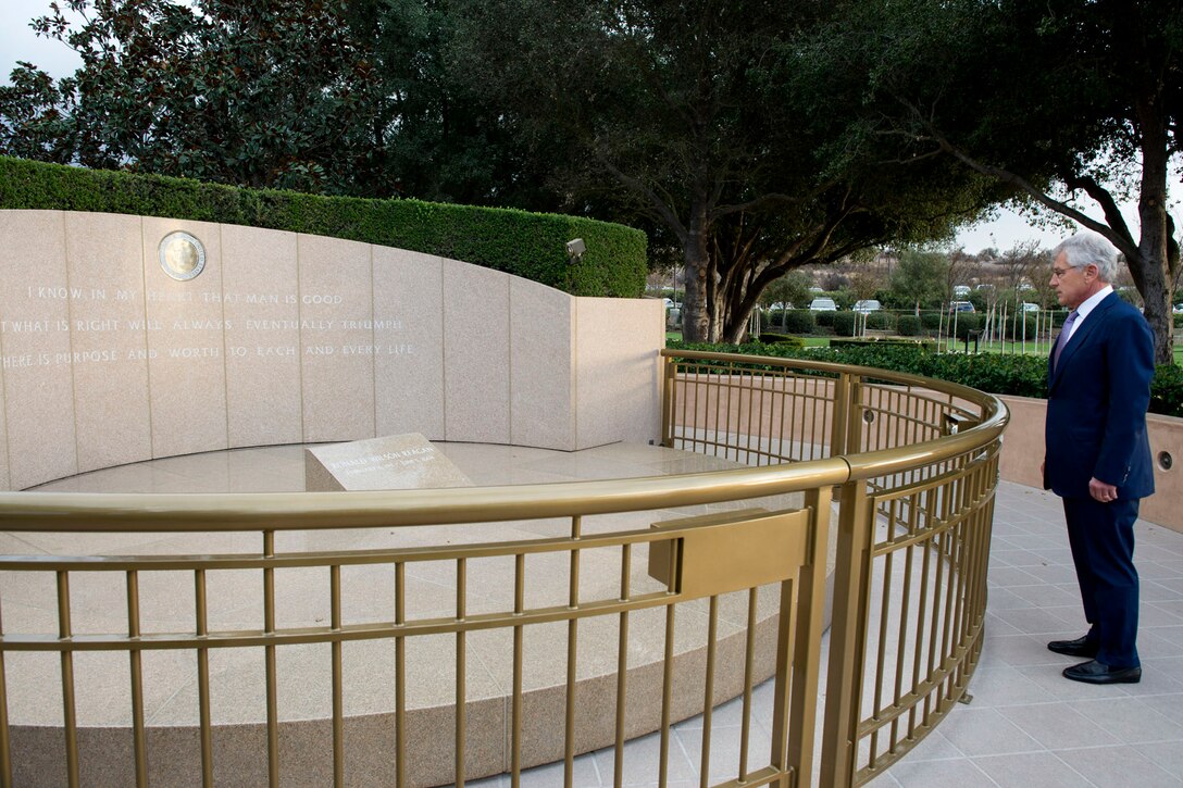 Defense Secretary Chuck Hagel stands at the grave of President Ronald Reagan before attending the Peace Through Strength Forum and Awards dinner at the Ronald Reagan Presidential Library in Simi Valley, Calif., Nov. 16, 2013. Hagel delivered remarks at the Reagan National Defense Forum and at the awards dinner where former Secretary Robert Gates and Sen. Carl Levin received the Peace through Strength award.