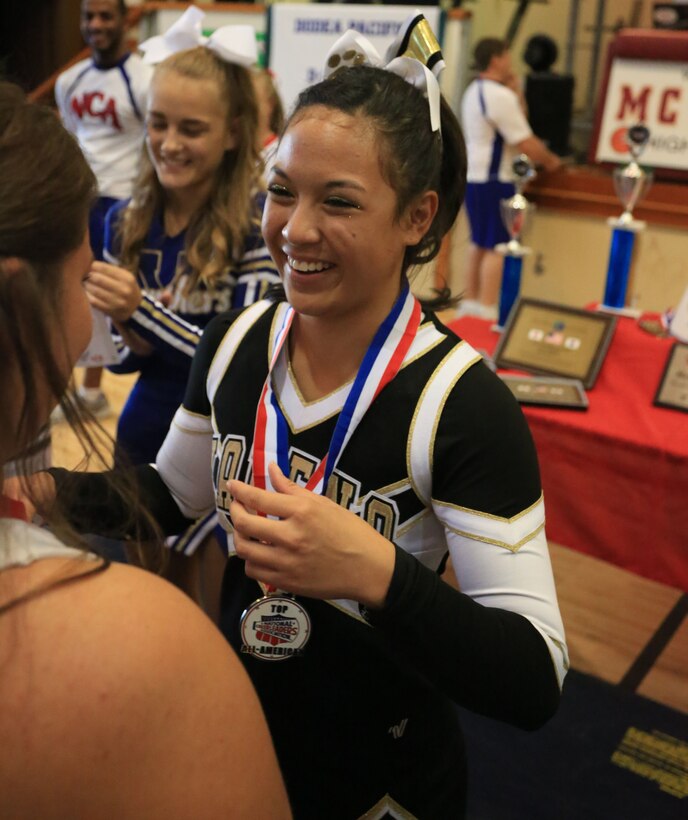 Erika Bongo, a Kadena High School sophomore, Kadena Air Base, Okinawa, Japan, smiles and thanks the National Cheerleading Association instructors after she was named the top all-American at the end of a five-day-cheerleading camp, Nov. 8, 2013. Bongo, said she didn’t have any idea she wanted to try out for all-American until the beginning of this year’s cheerleading season.