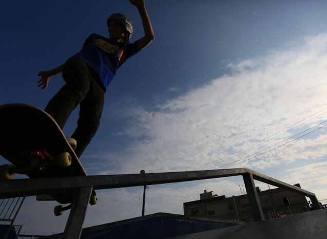 J.C. Pearson, 12, performs a frontside boardslide during a skate competition at XtremeWorks Skate Park aboard Marine Corps Air Station Iwakuni, Japan, Nov. 9, 2013. Pearson placed first in the game of S.K.A.T.E., which is similar to the basketball game H.O.R.S.E.