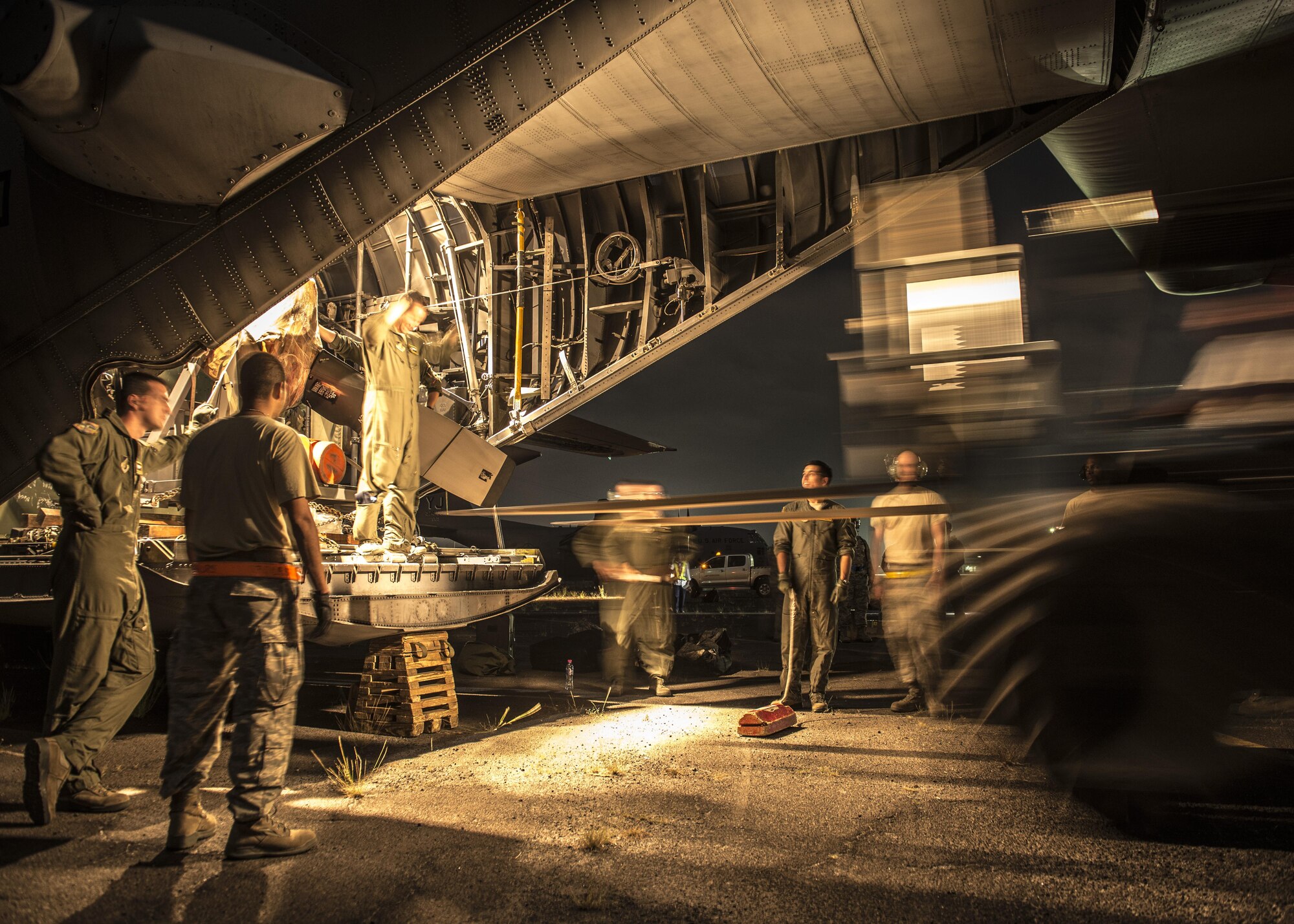 Airmen from Yokota Air Base, Japan, offload equipment from a C-130 Hercules at Clark Air Base, Republic of the Philippines, Nov. 16, 2013. The C-130 is considered a tactical airlift workhorse; capable of preforming air-land and airdrop missions out of remote locations. 