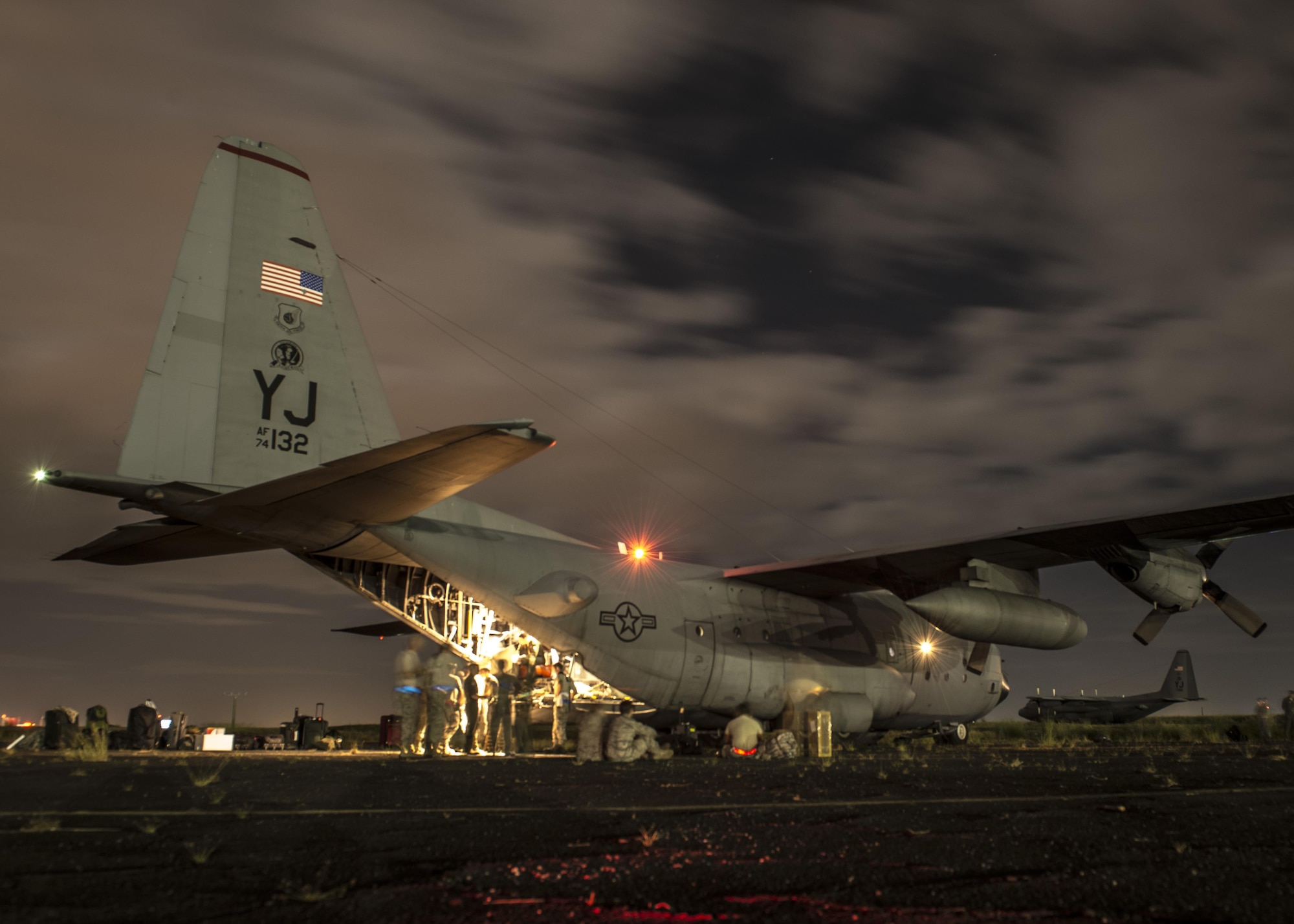 Airmen from Yokota Air Base, Japan, prepare to offload equipment from a C-130 Hercules at Clark Air Base, Republic of the Philippines, Nov. 16, 2013. The C-130 is considered a tactical airlift workhorse; capable of preforming air-land and airdrop missions out of remote locations. 