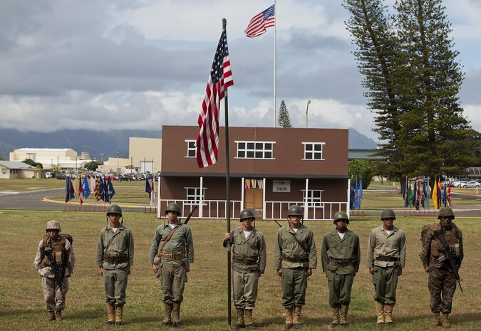 Marines dressed in different uniforms of the Marine Corps stand side-by-side before the colors are retired from the parade deck during the final moments of the 2013 Marine Corps Base Hawaii birthday pageant at Dewey Square, Nov. 8, 2013. (U.S. Marine Corps photo by Lance Cpl. Matthew Bragg)