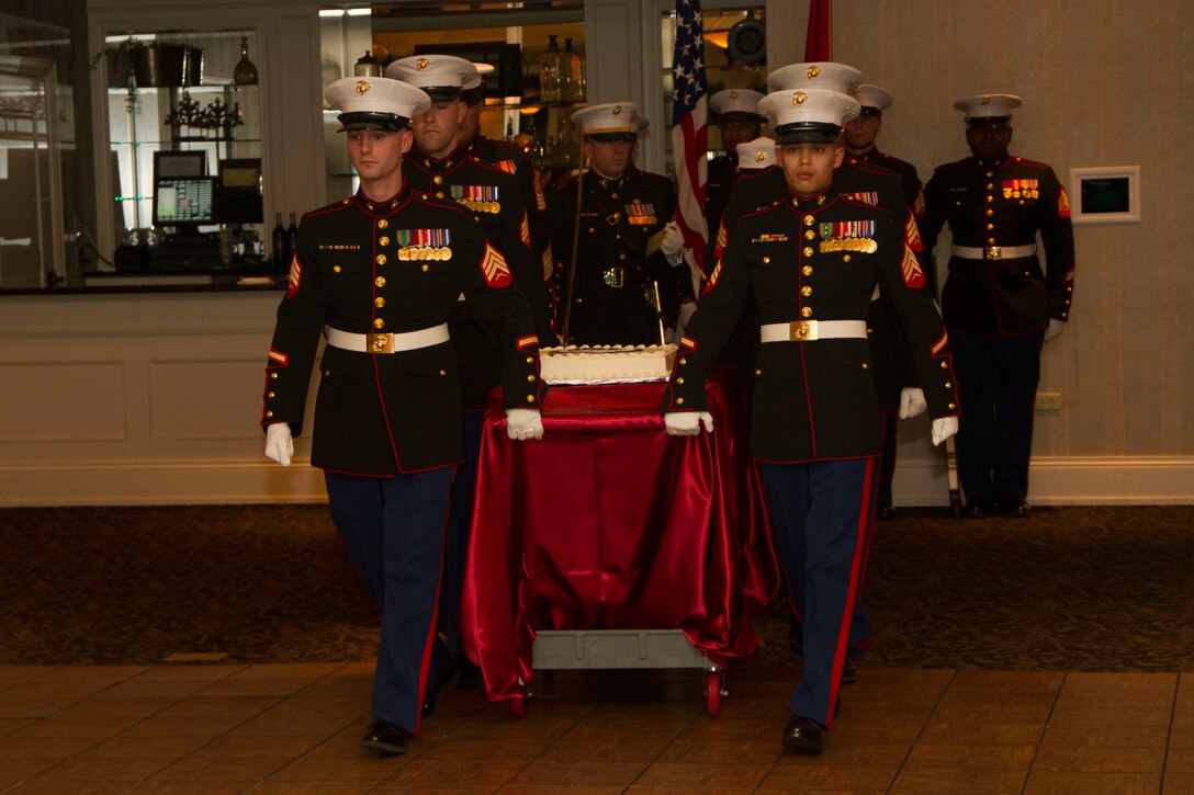 Recruiting Station Milwaukee’s cake detail escorts the birthday cake as part of the birthday ball ceremony at the Waterfront Restaurant and Tavern, on November 15, 2013.  The first piece of cake was given to the guest of honor, Sergeant Major of the Marine Corps Sgt. Maj. Micheal P. Barrett.  The second piece was given to the oldest Marine, retired Master Gunnery Sgt. Bradley Chandler, and passed on to the youngest Marine, Pfc. Rylee Stocco.