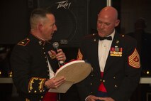 Maj. Charles D. Godwin, Recruiting Station Milwaukee Commanding Officer, presents Sgt. Maj. Micheal P. Barrett, 17th Sgt. Maj. of the Marine Corps, with an RS Milwaukee plaque during the birthday ball ceremony at the Waterfront Restaurant and Tavern, on November 15, 2013.  Sgt. Maj. Barrett was the guest of honor for the ball.