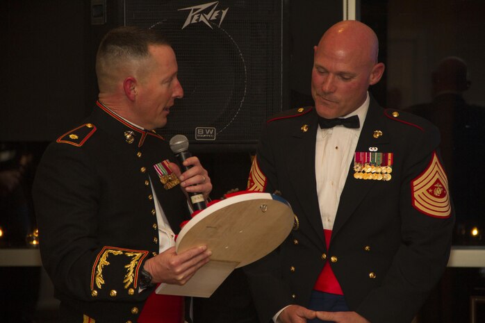 Maj. Charles D. Godwin, Recruiting Station Milwaukee Commanding Officer, presents Sgt. Maj. Micheal P. Barrett, 17th Sgt. Maj. of the Marine Corps, with an RS Milwaukee plaque during the birthday ball ceremony at the Waterfront Restaurant and Tavern, on November 15, 2013.  Sgt. Maj. Barrett was the guest of honor for the ball.