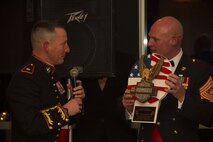 Maj. Charles D. Godwin, Recruiting Station Milwaukee Commanding Officer, presents Sgt. Maj. Micheal P. Barrett, 17th Sgt. Maj. of the Marine Corps, with an RS Milwaukee plaque during the birthday ball ceremony at the Waterfront Restaurant and Tavern, on November 15, 2013.  Sgt. Maj. Barrett was the guest of honor for the ball.