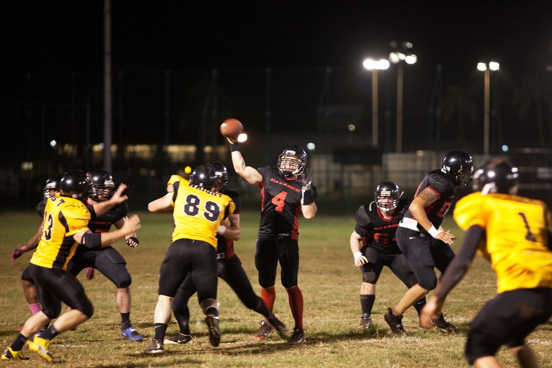 The 1st Battalion, 12th Marine Regiment Savages’ quarterback throws the football downfield while inside of the pocket during a football game at Riseley Field, Nov 5, 2013.(U.S. Marine Corps photo by Cpl. Nathan Knapke) 
