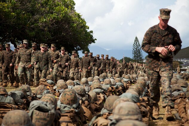 Marines and sailors with 3rd Marine Regiment cover and align their gear after a six-mile hike around base and gather in front of the 3rd Marine Regiment building for a Marine Corps birthday cake-cutting ceremony, Nov. 7.(U.S. Marine Corps photo by Cpl. Nathan Knapke)