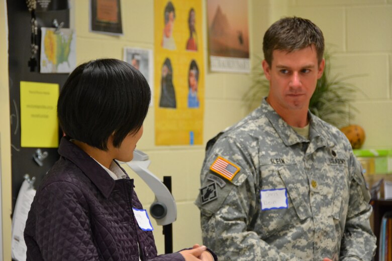 Middle East District civil engineers Qing Xu and Deputy Commander Maj. Chris Klein share personal educational paths and work experiences to becoming engineers with nearly 60 students at the career fair.