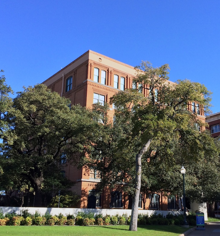Fifty years after the assassination of President John F. Kennedy, the view from the sixth floor of the Texas School Book Depository is obscured by trees.